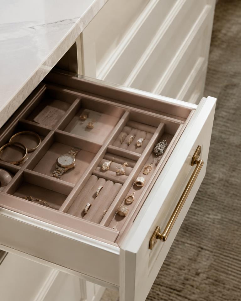 Blush-lined jewelry drawer with a brass pull